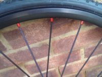 Red anodised nipples seat aluminium spokes into the rims