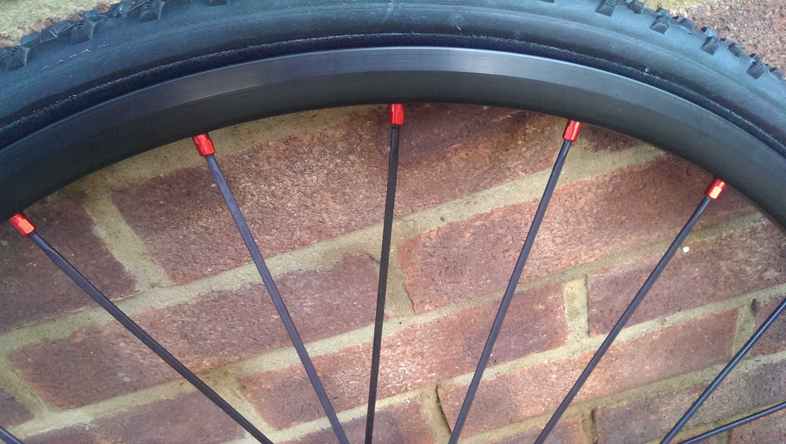Red anodised nipples seat aluminium spokes into the rims
