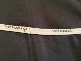 Reflective 'Vélobici' top pocket, sleeve cuff and hem binding detail