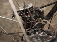 A cable pulling on a lever operates the hydraulic piston, simple and will work with standard road levers