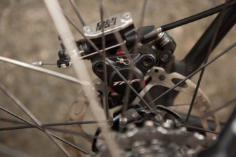 A cable pulling on a lever operates the hydraulic piston, simple and will work with standard road levers