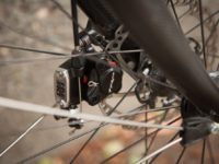 A cable pulling on a lever operates the hydraulic piston, simple and will work with standard road levers