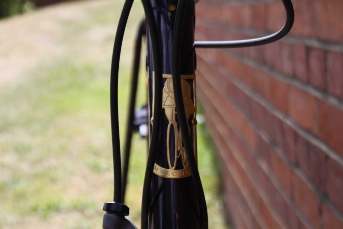 A hand-cut headtube badge adorns the front of the Malcolm Custom Bicycles frame