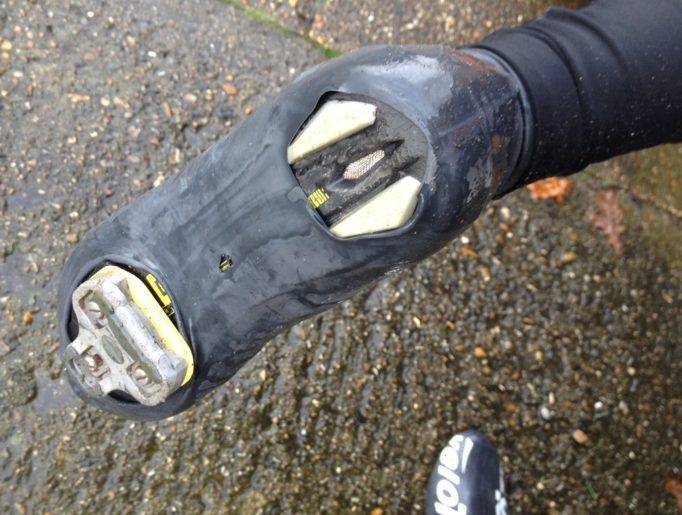Underneath the Velotoze Tall Shoe Covers, you can see a small hole caused by walking on rough surfaces 