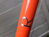 Stainless steel graphics show through the orange paintwork