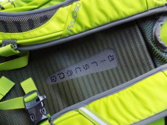 A ridged and shaped foam back makes for a comfortable carry. The straps also use foam. Cut outs and mesh on both help with heat control. And there's a whistle on the chest strap!