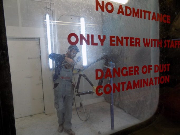 A frame gets it finishing touches in the Cycles Perfecta spray booth