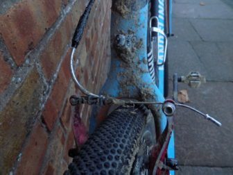 The adjuster on top of the 'noodle' allows you to adjust cable tension. A rubber boot sits at the end, keeping the mud at bay