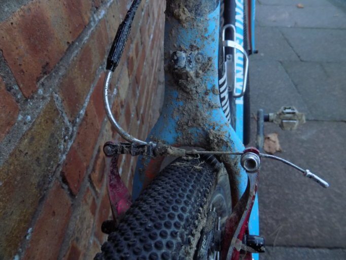 The adjuster on top of the 'noodle' allows you to adjust cable tension. A rubber boot sits at the end, keeping the mud at bay