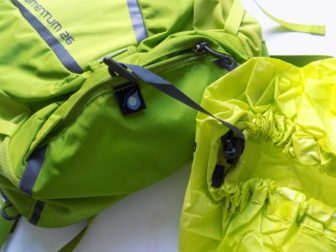 The rain cover has it's own storage pocket and yes, it works!