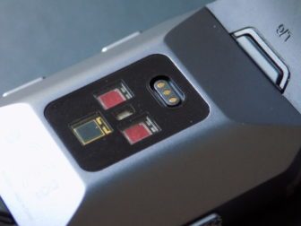 Around the back are three optical sensors and a magnetic charging port