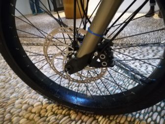 Four calipers and a 203mm rotor handle front braking