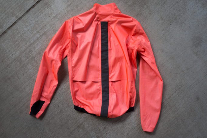 back view of the Assos ÉQUIPE RS jacket laying on cement