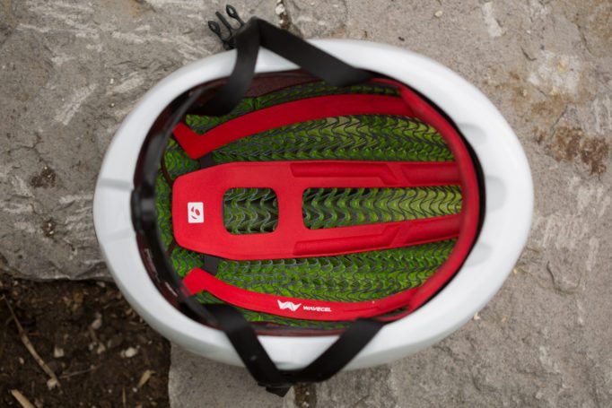 inside of a road bike helmet laying on a stone planter