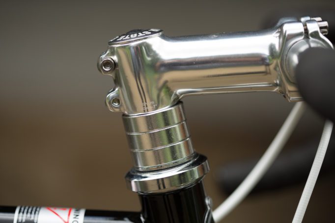 Chrome spacers stacked on the top of a steel raod bike with an out of focus background.