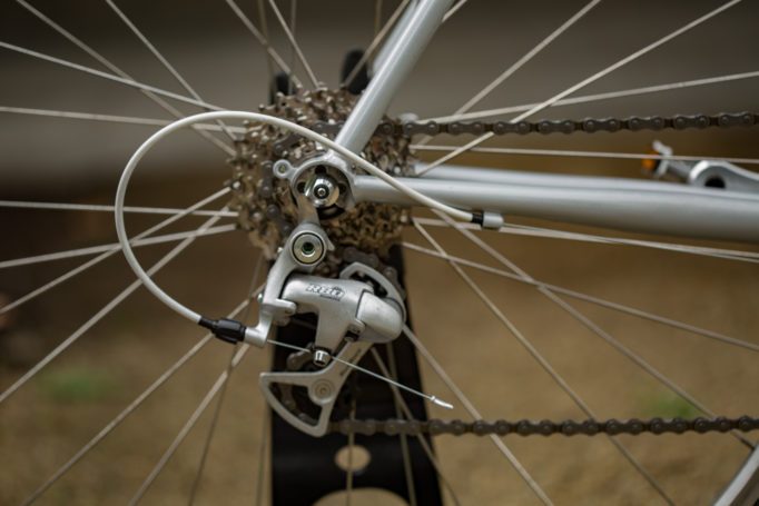 rear cassette and derailleur on a road bike with an out of focus background