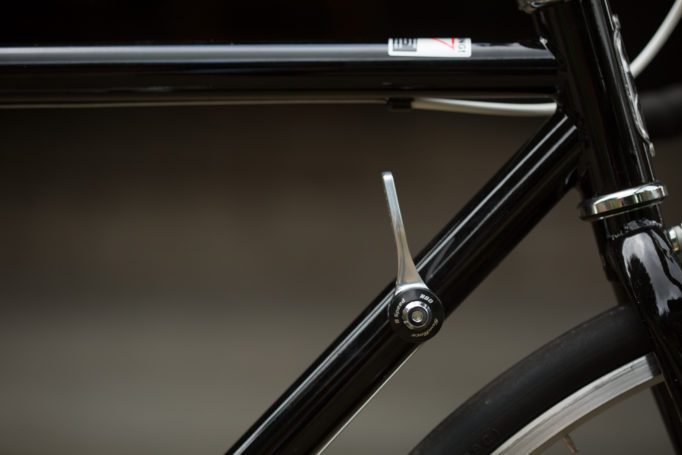 Side view of the front of a bicycle frame with a downtube shift lever
