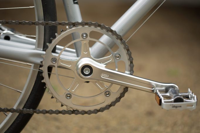 side shot of the State Bicycles 4130 CNC machined crank with an out of focus background.